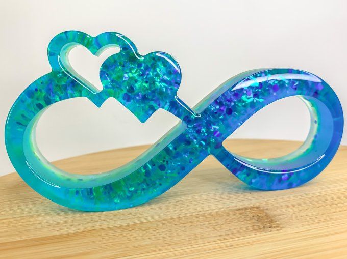Symbole infini double bleu et paillettes holographiques 