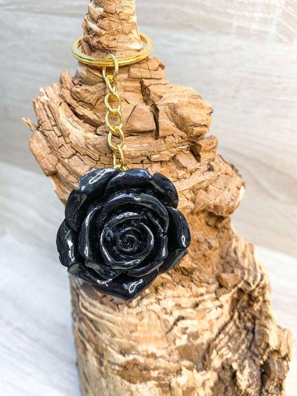 Porte-clés fleur noir nacré (attache or)